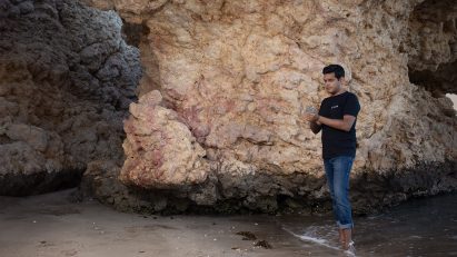 Talal Hasan standing in front of a rock formation