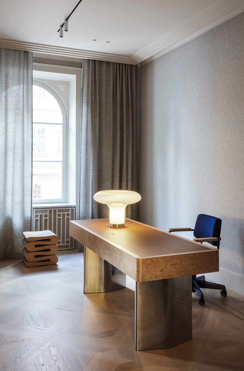 An office with a wooden desk and blue office chair