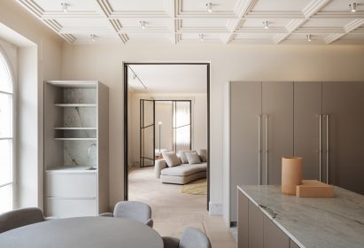 White kitchen with grey table and storage spaces