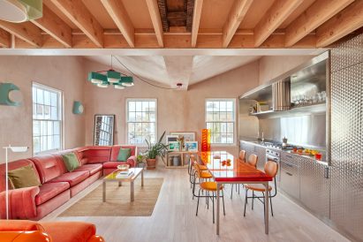 Living room with exposed plaster walls and bright furniture
