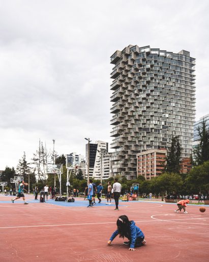 Children playing in sports courts beside Iqon tower