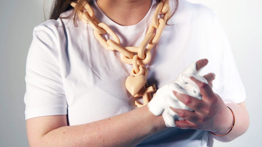 Person washing hands using necklace made of soap