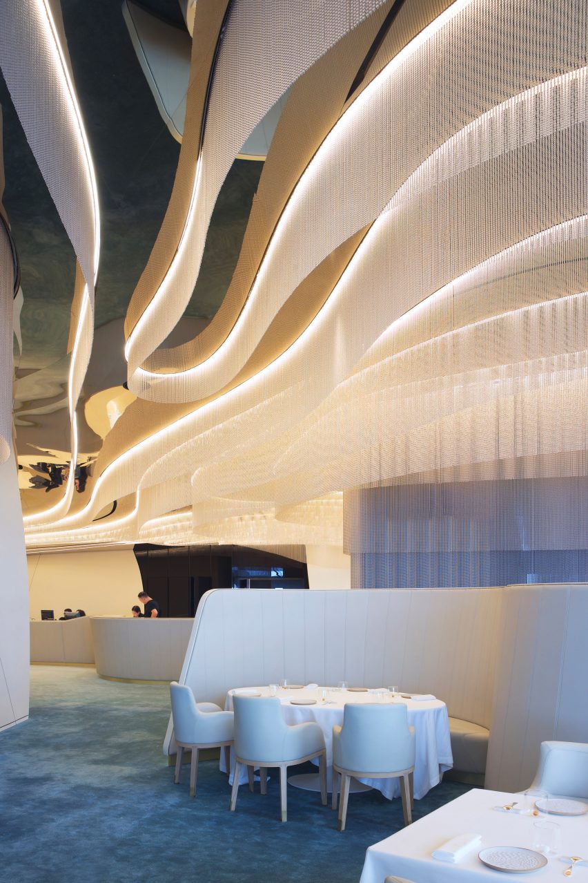 Beige chairs and blue carpet in restaurant