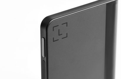 Close-up on the back of the Ledger Stax device showing "L" branding