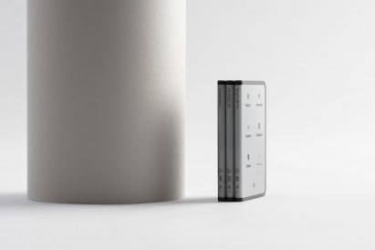 Three Ledger Stax devices stacked upright like ledgers