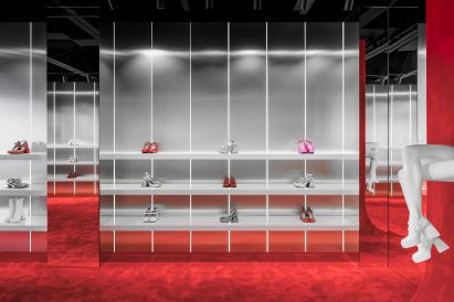 White shelves in front of brushed chrome walls