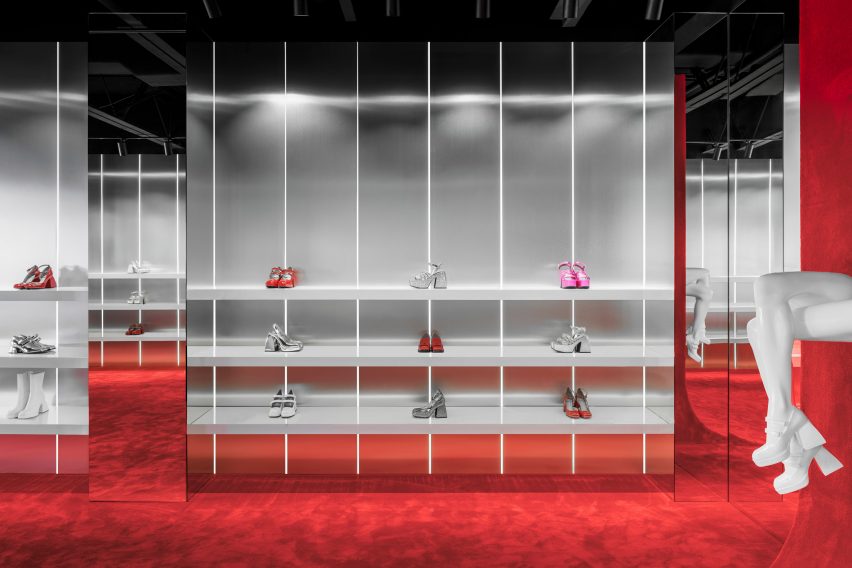 White shelves in front of brushed chrome walls