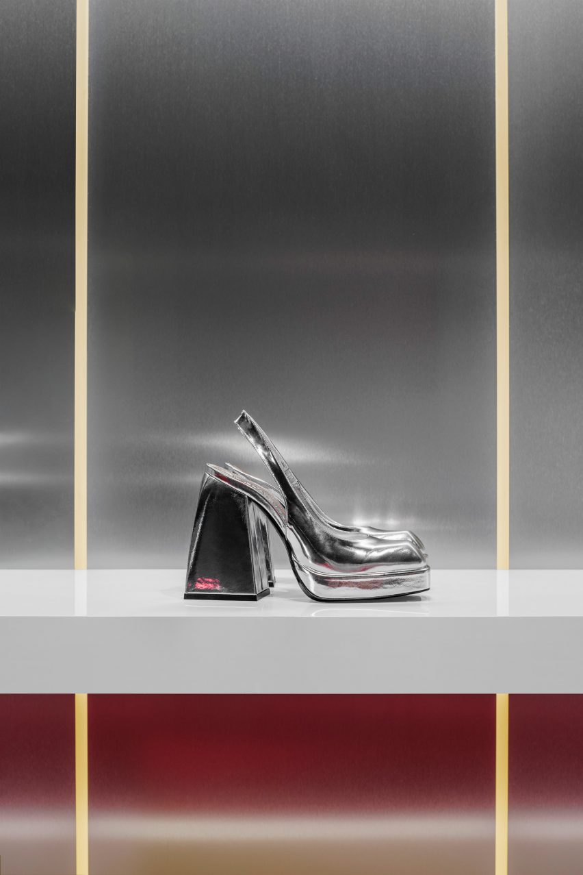 Silver heel on white shelf