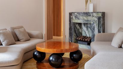 Circular wooden table with ball legs in Stockholm flat