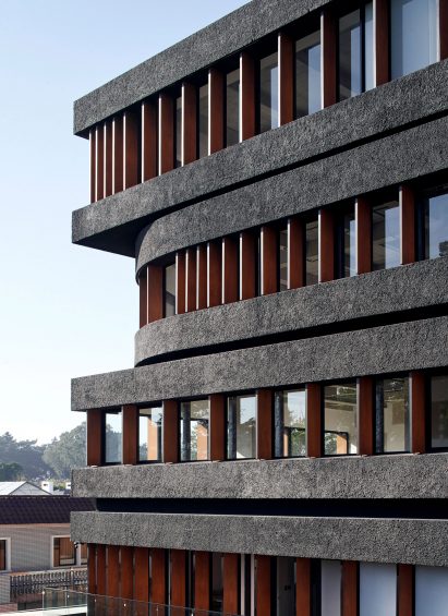 Dark bands on facade of mixed-use AEME building