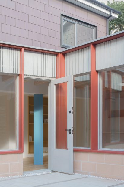 Pale-pink concrete blockwork with cloister-like facade