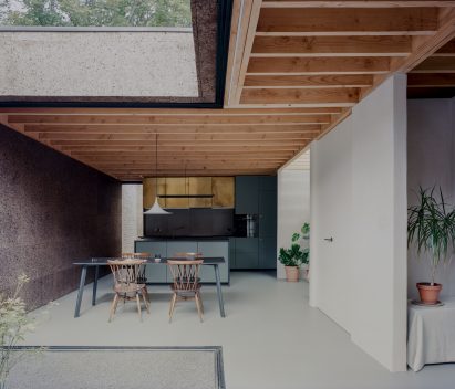 Interior image of the kitchen and dining area with white floor