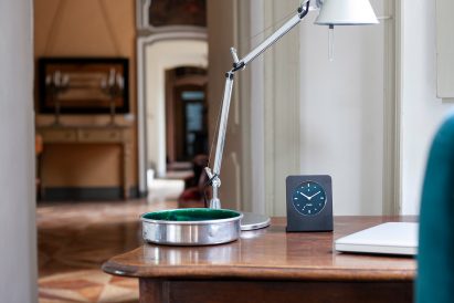 Black clock sitting on desk
