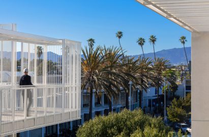 Stucco and perforated mesh screen on low-cost housing building