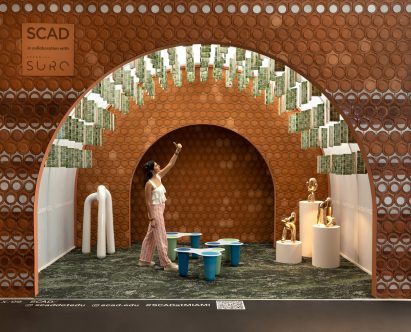 Person standing in SCAD’s booth at Design Miami/