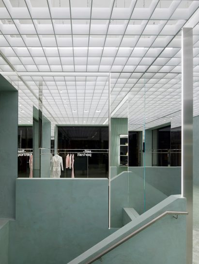 Interior image of a clay covered bannister at the Self-Portrait store