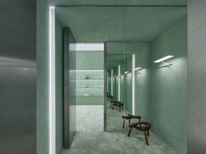 Interior image of a green fitting room that was covered in a plush carpet