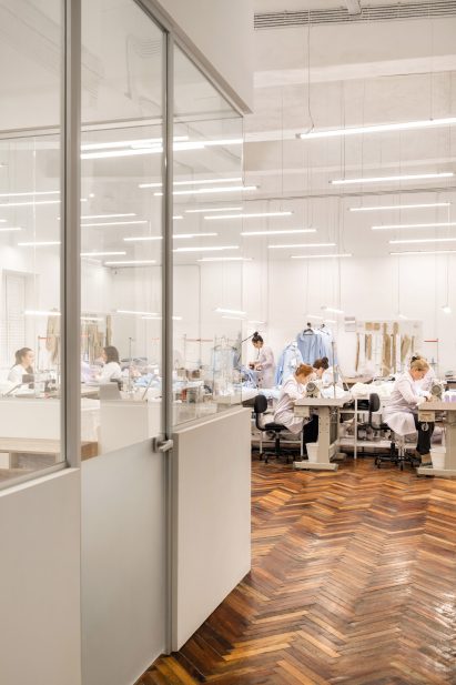 Photograph showing seamstresses in work room with parquet flooring