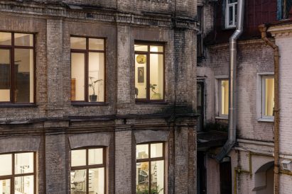 Photograph showing outside of building with illuminated windows