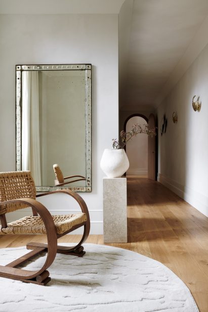 Apartment hallway with rocking chair and vase on a plinth