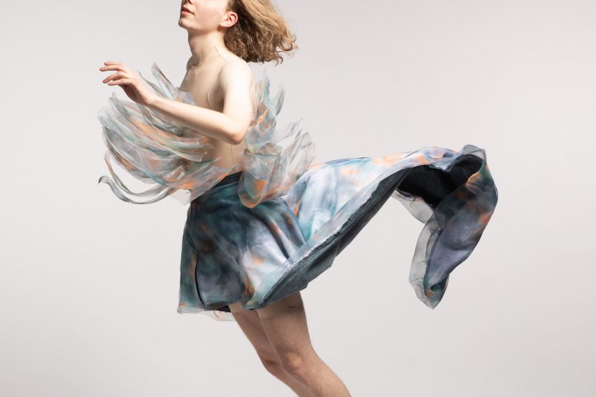 Photograph of person wearing garment that billows out behind them