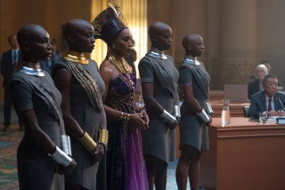 A queen and her aides on a film set