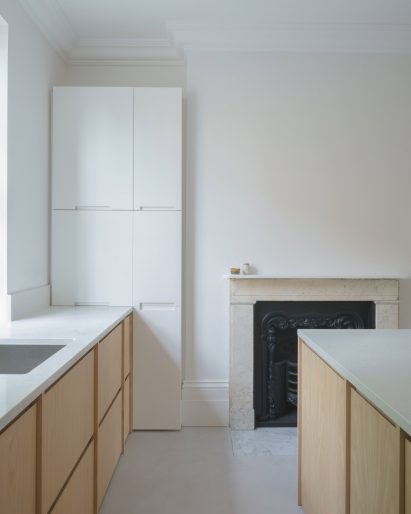 Kitchen of with wooden cabinets and small fireplace