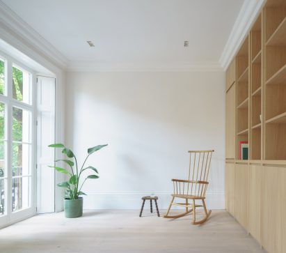 Living room with built-in storage and rocking chair