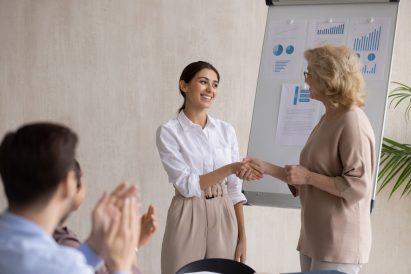 A student shaking hands with a university professor