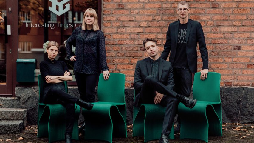 Photo of people sat on green chairs