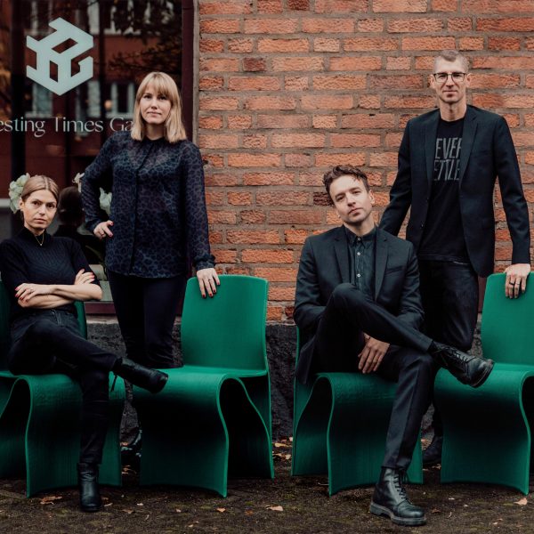 Photo of people sat on green chairs