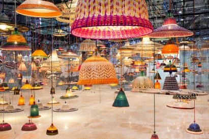 Photo of lamp shades hanging in a mirrored room
