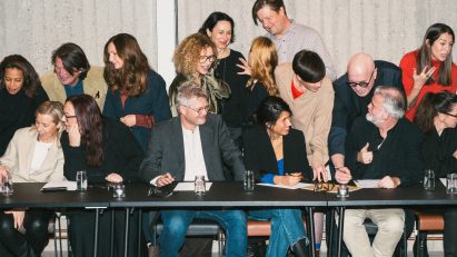Image of group of people sat at a table