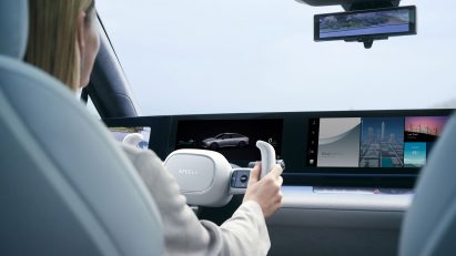 Rear view of woman's hands on a steering wheel
