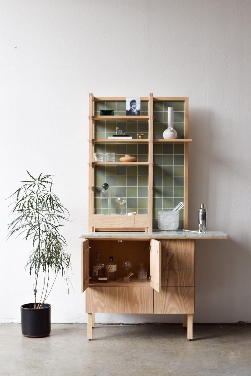 Photograph of cabinet with open cupboard and cannabis plant beside it