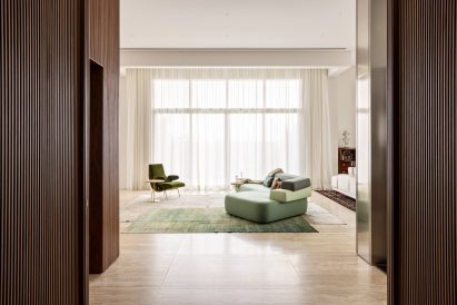 Green sofa among neutral decor