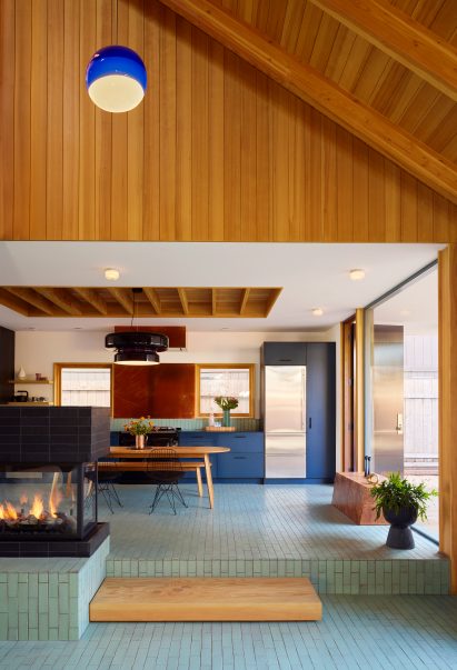 Thin, glazed brick on the floor of a kitchen within gabled volume