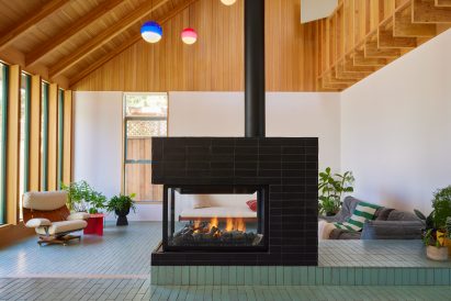 Living room with gabled roof and large geometric chimney in the centre