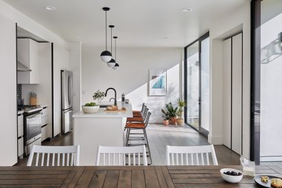 Open-plan kitchen and dining space within Common Melrose housing in Los Angeles