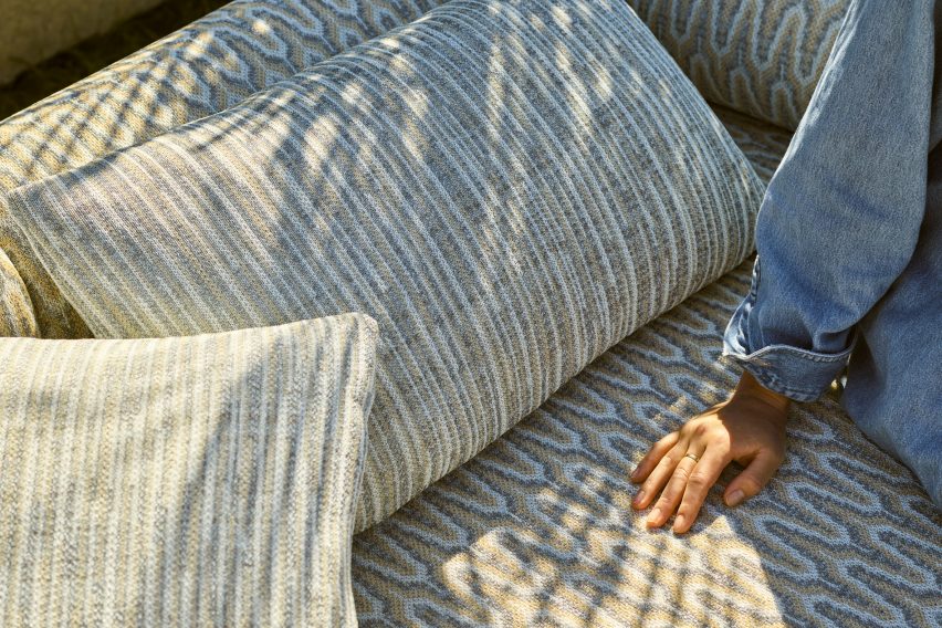 Detail showing blue green upholstered pillows and bench