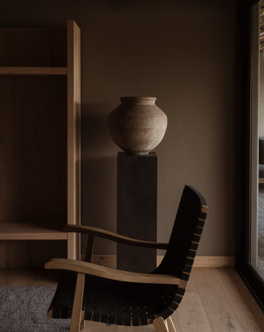 Chair and vase against a dark wall