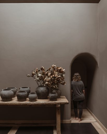 Arched doorway beside a table covered with vases