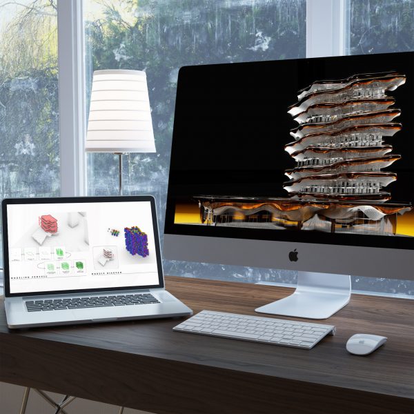 Laptop and desktop screens showing a student computational design of a large building