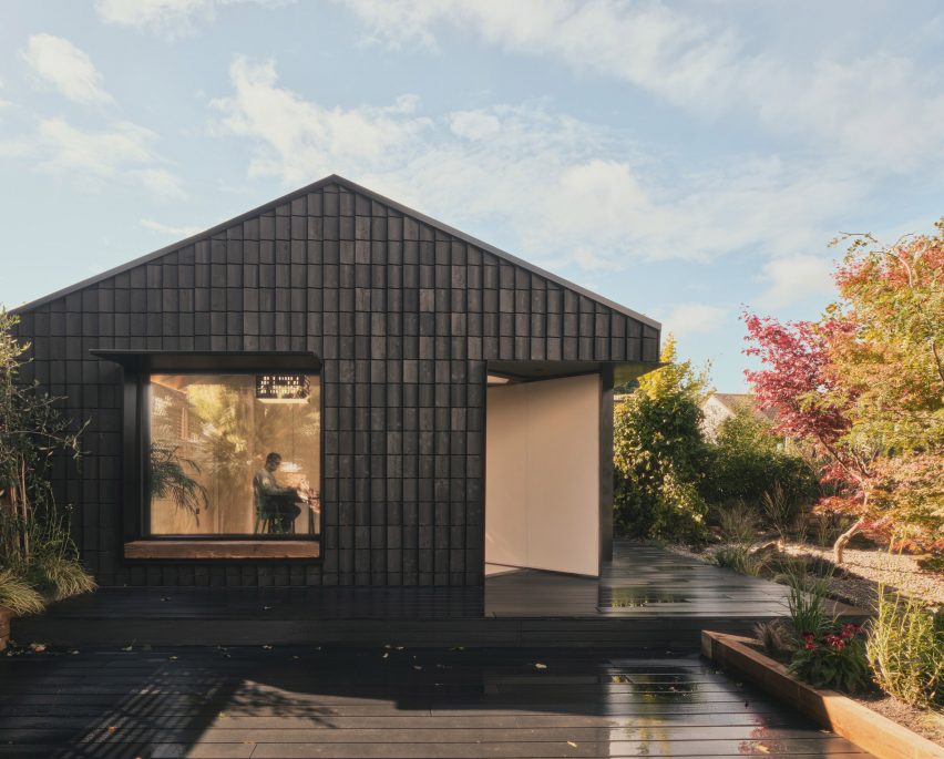 Charred timber facade of Dark Matter garden studio by Hyper