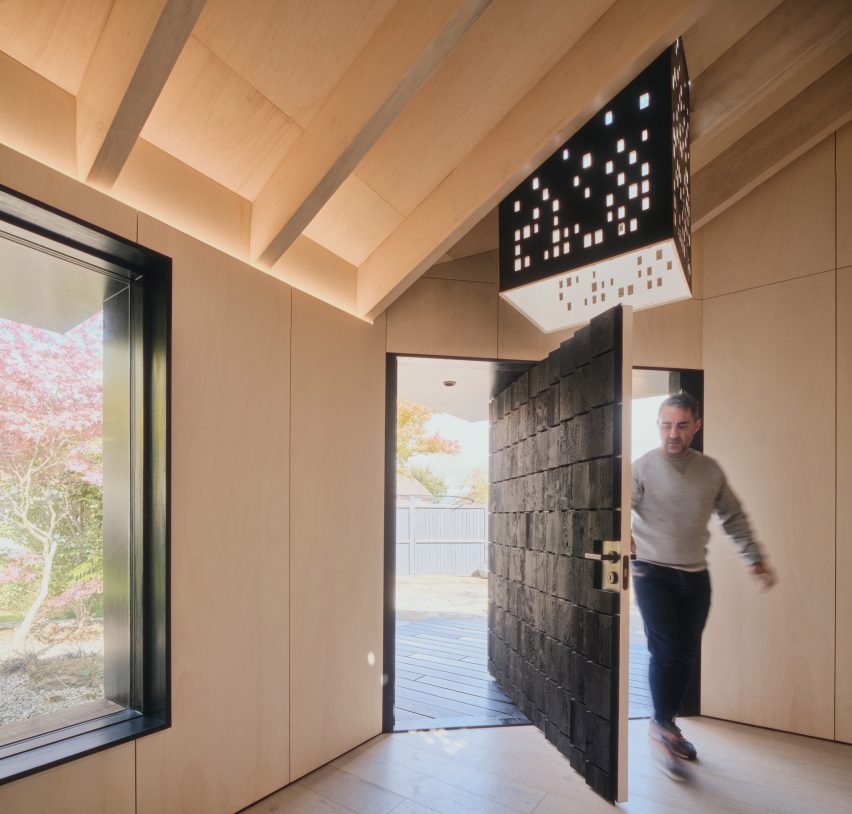 Pivoting door of Dark Matter garden studio by Hyper