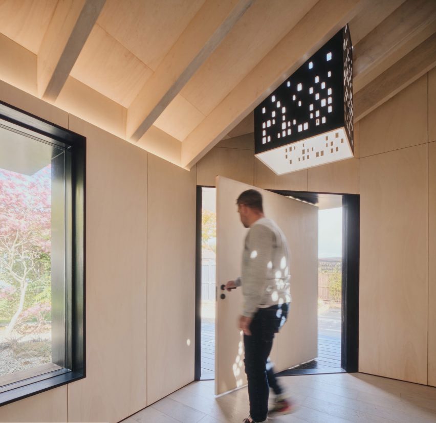 Pivoting door of Dark Matter garden studio by Hyper