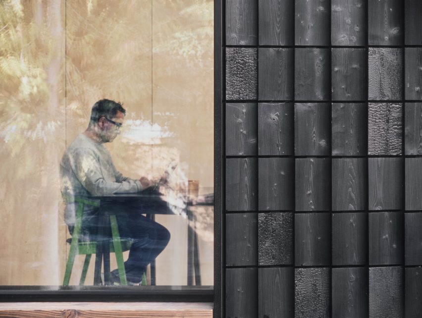 View through window of Dark Matter garden studio by Hyper