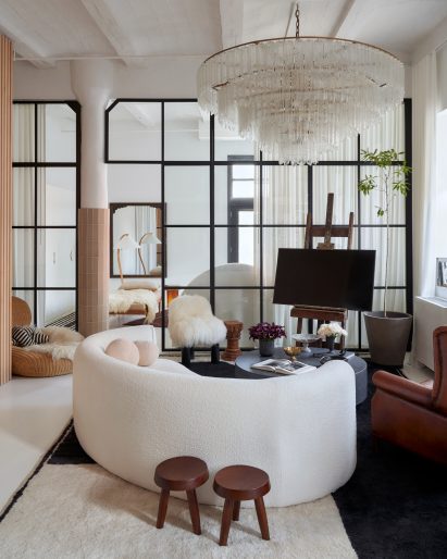 Living space with curved sofa and tiled columns