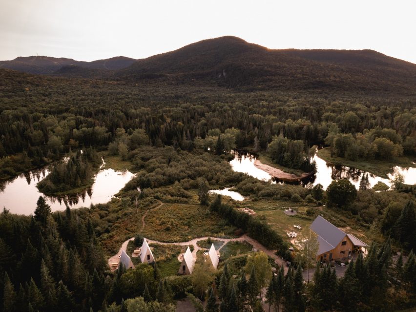 Aerial view of Farouche Tremblant buildings in a wild landscape near a winding river