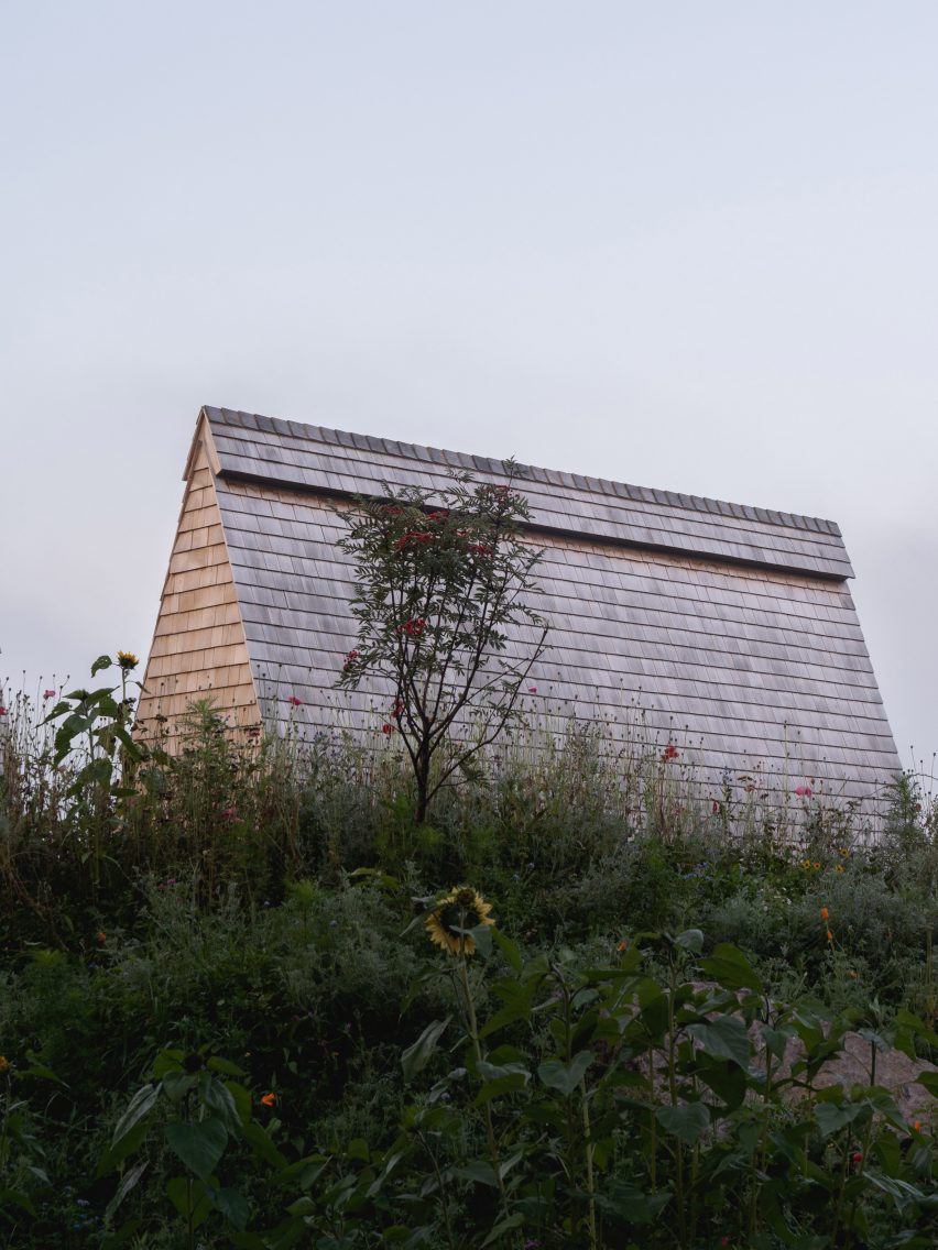 A-frame cabin with a roof clad in cedar shingles